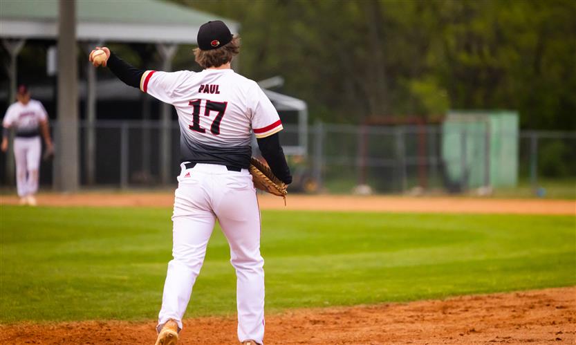 A Ravenwood High baseball player throws the ball.